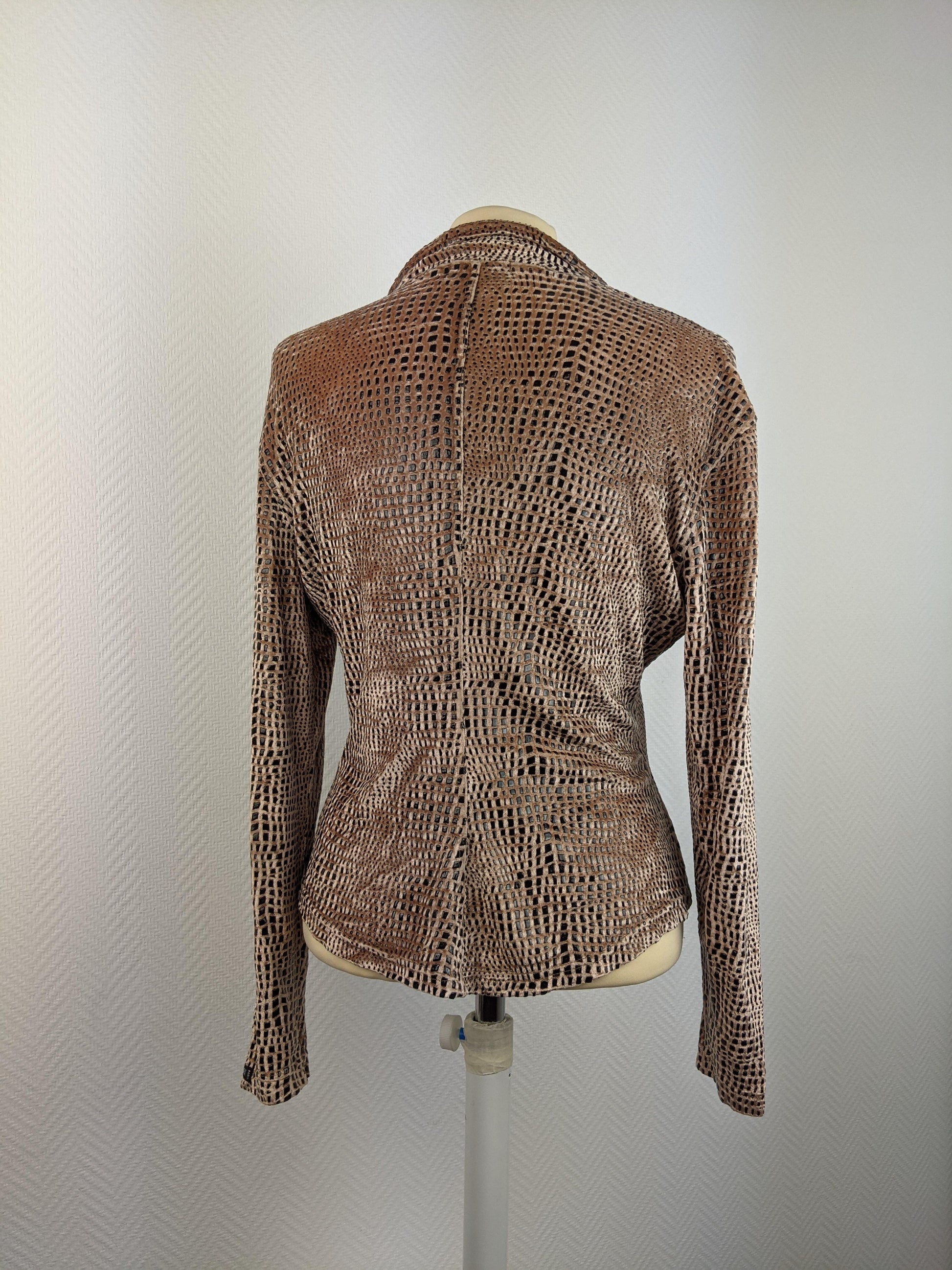 Back view of animal print blouse on mannequin
