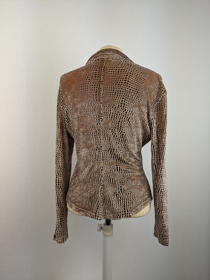 Back view of animal print blouse on mannequin
