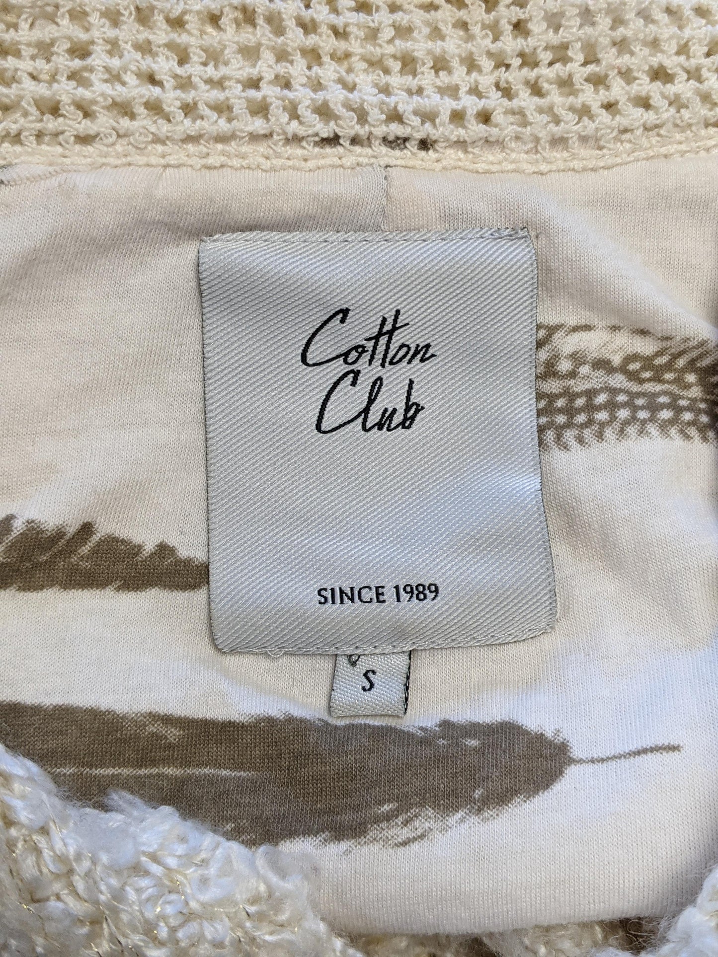 Label of Cotton Club cardigan showing brand and size