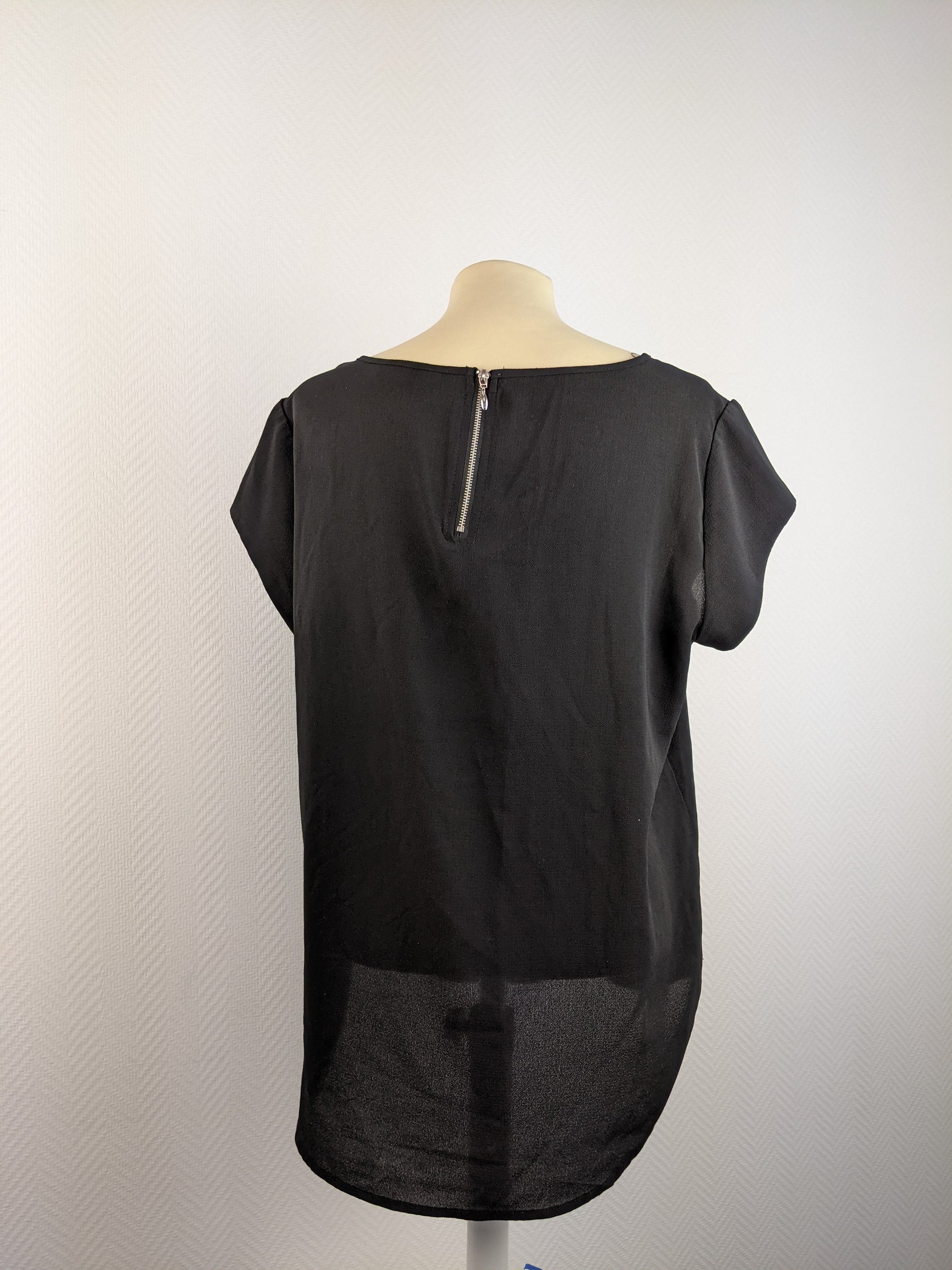 Back view of black short sleeve top with zipper