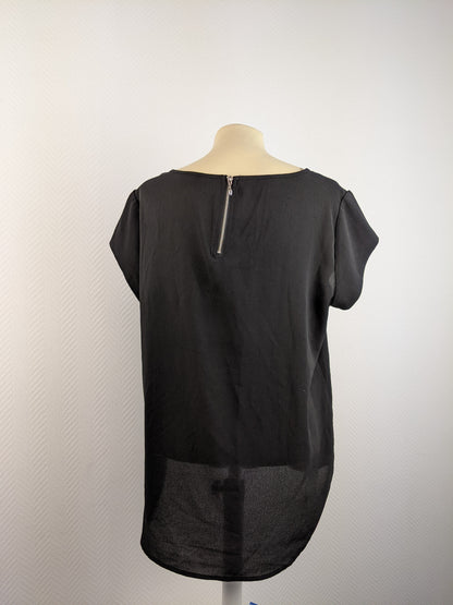Back view of black short sleeve top with zipper