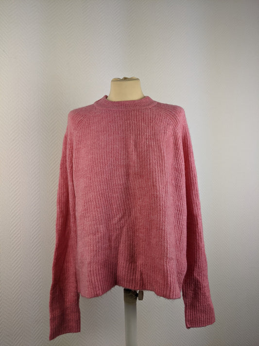 Front view of pink ribbed sweater