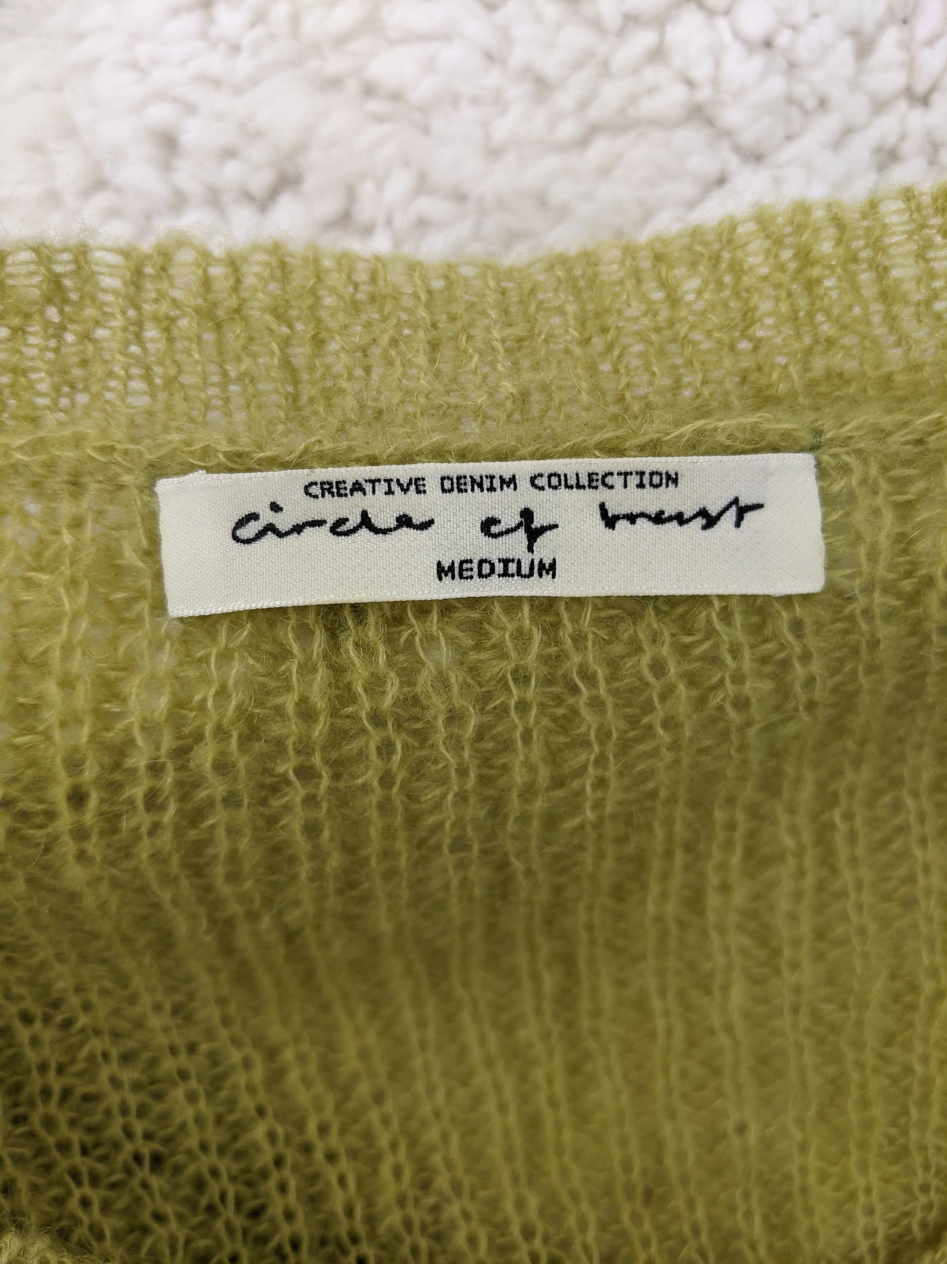 Label of the sweater showing brand and size