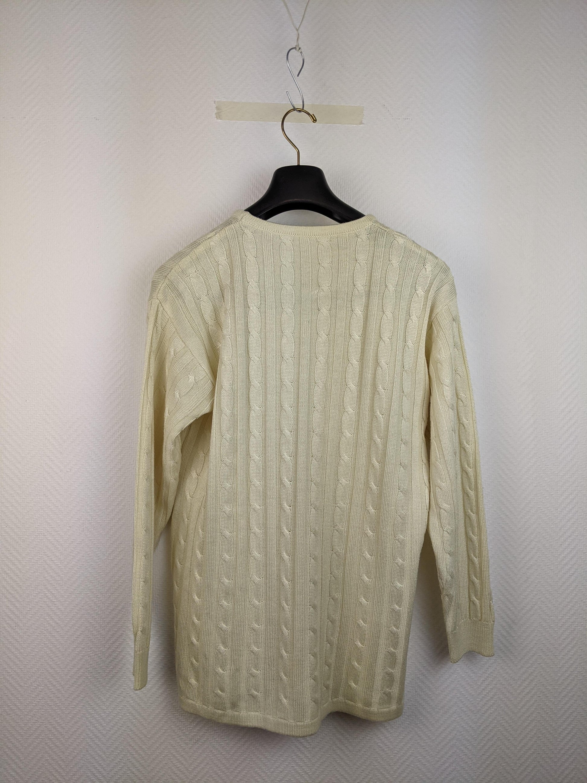 Back view of cream cable knit sweater