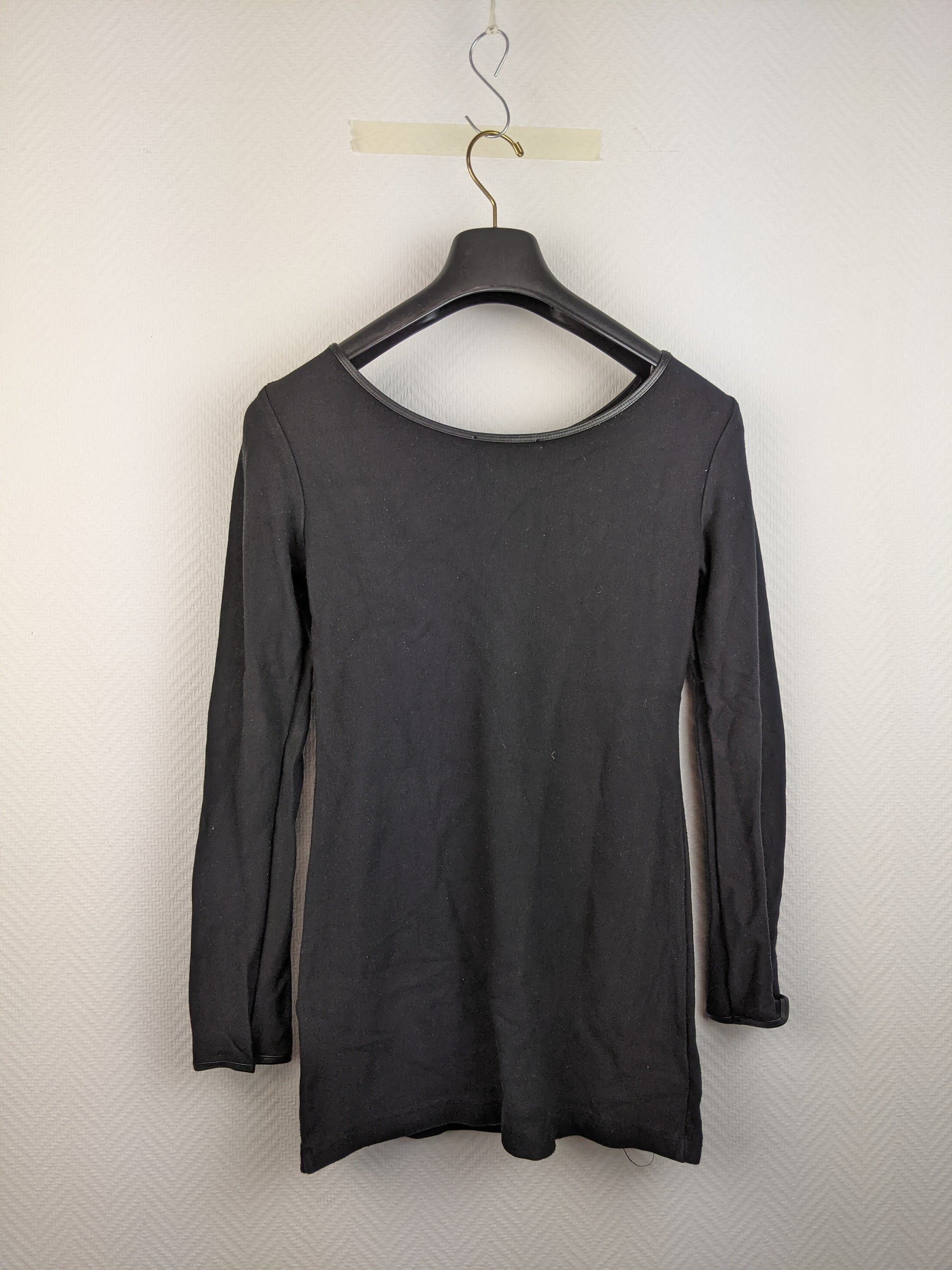 Back view of black long-sleeve top on hanger