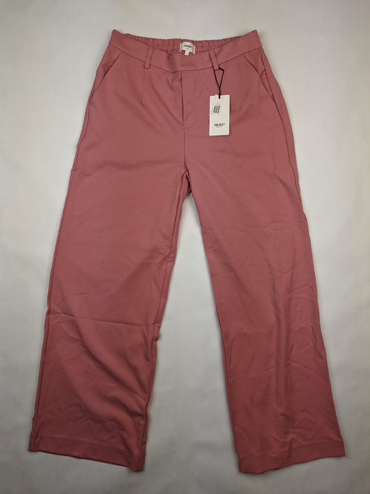 Front view of pink trousers with tags