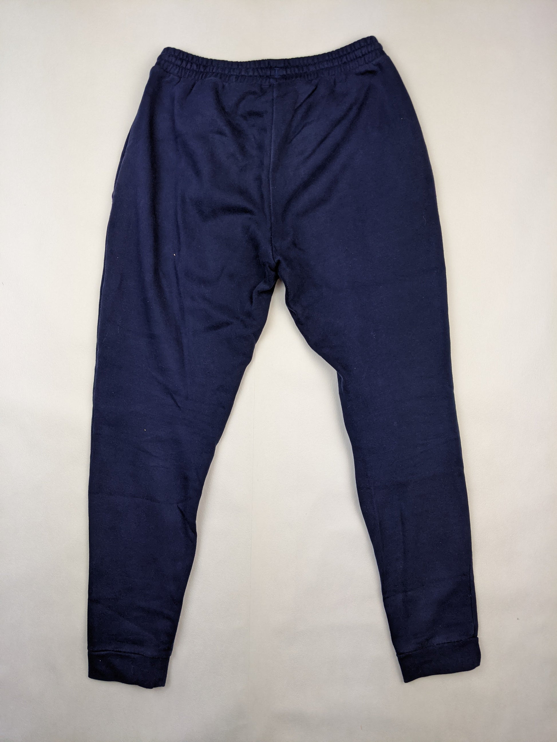 Back view of navy blue Adidas sweatpants