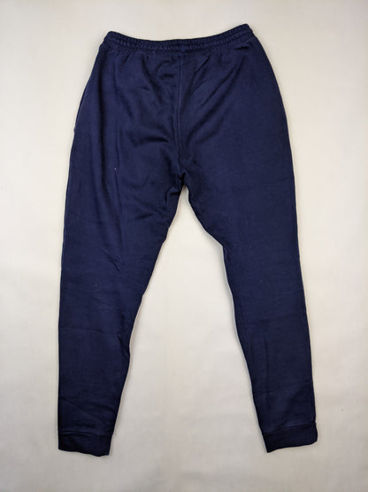 Back view of navy blue Adidas sweatpants