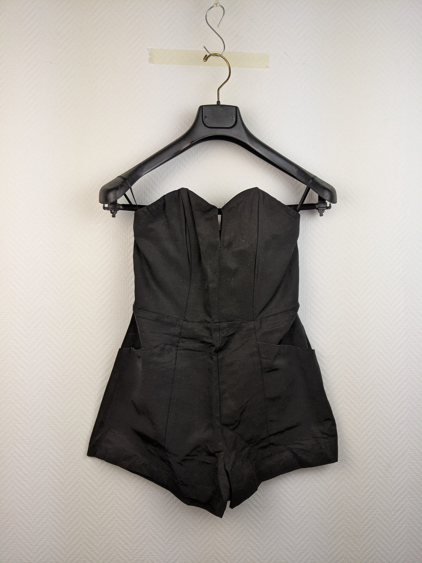 Front view of black strapless romper