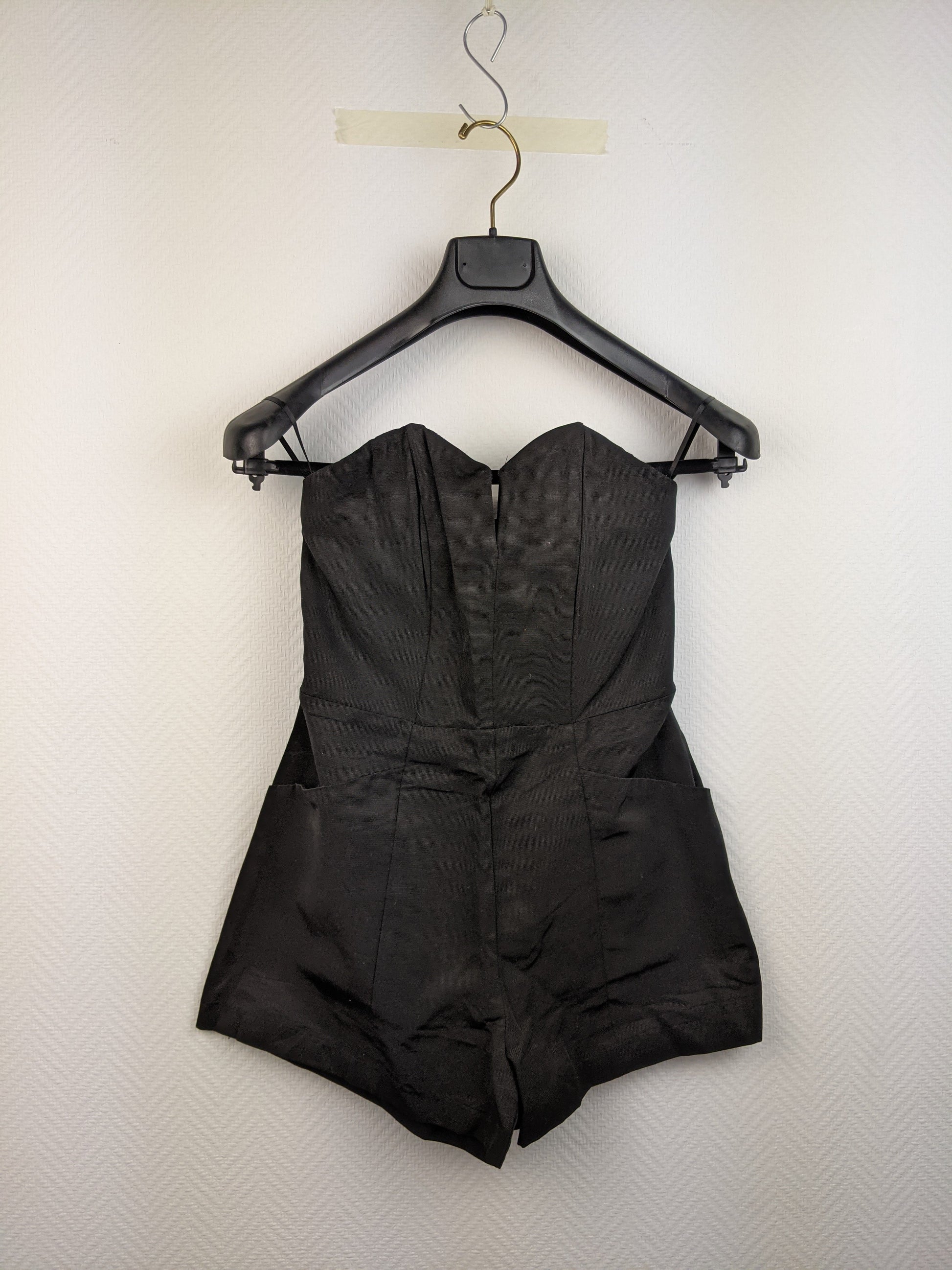 Front view of black strapless romper