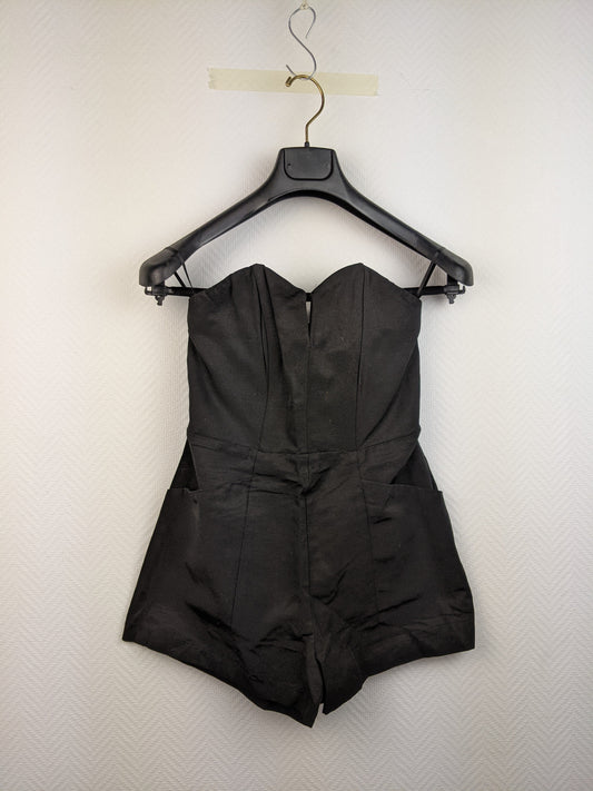 Front view of black strapless romper