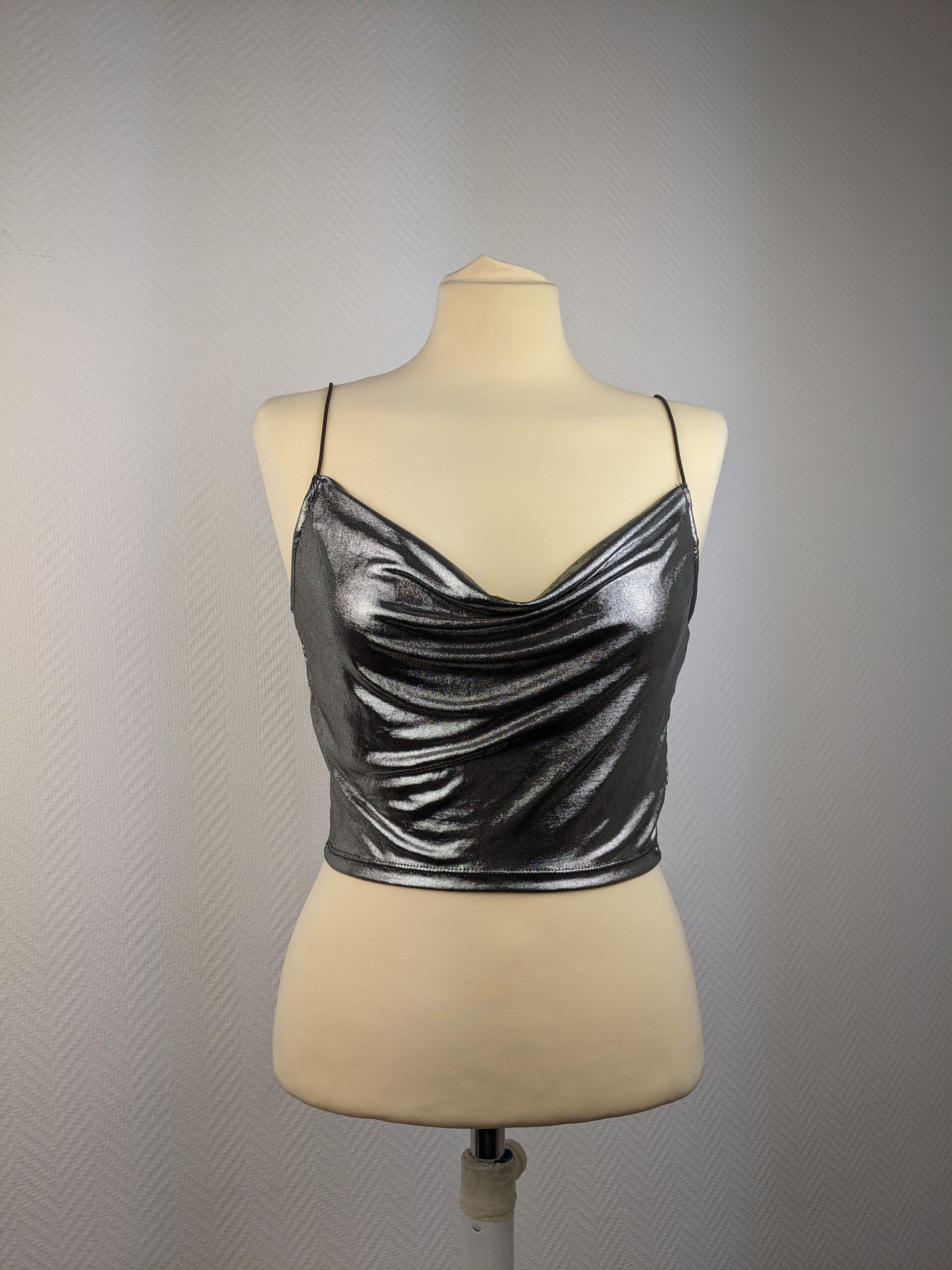 Front view of shiny silver cami top on mannequin