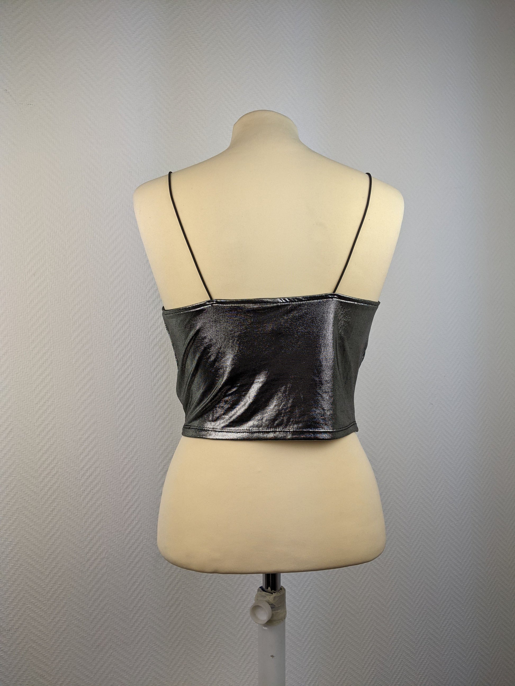 Back view of shiny silver cami top on mannequin