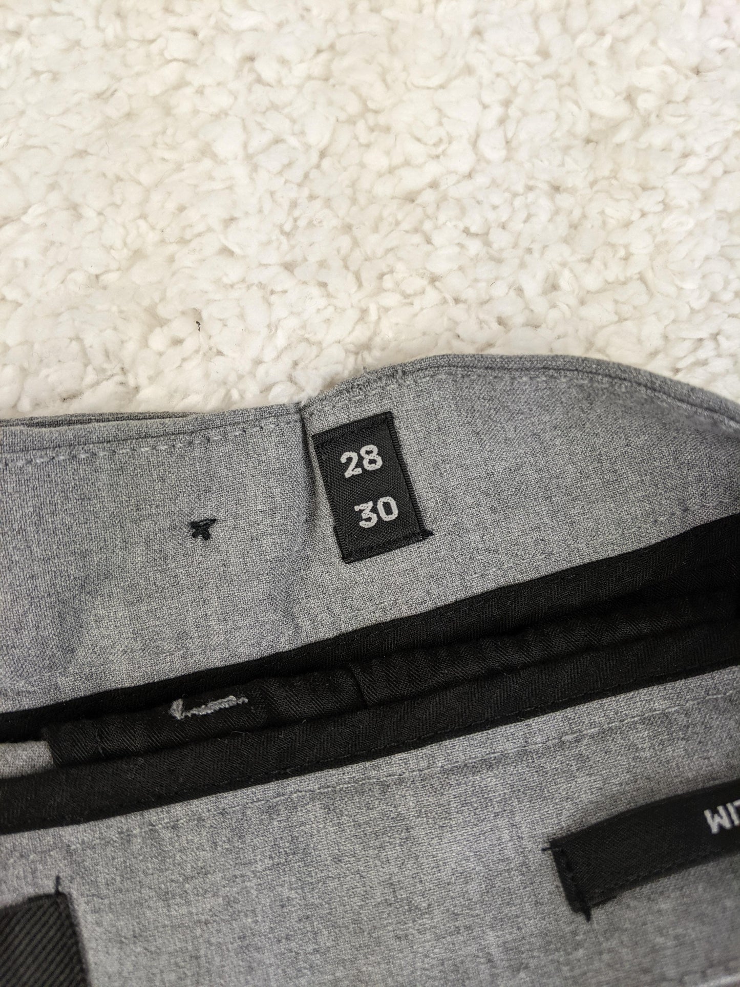 Size label of Jack & Jones grey pants showing size 28/30