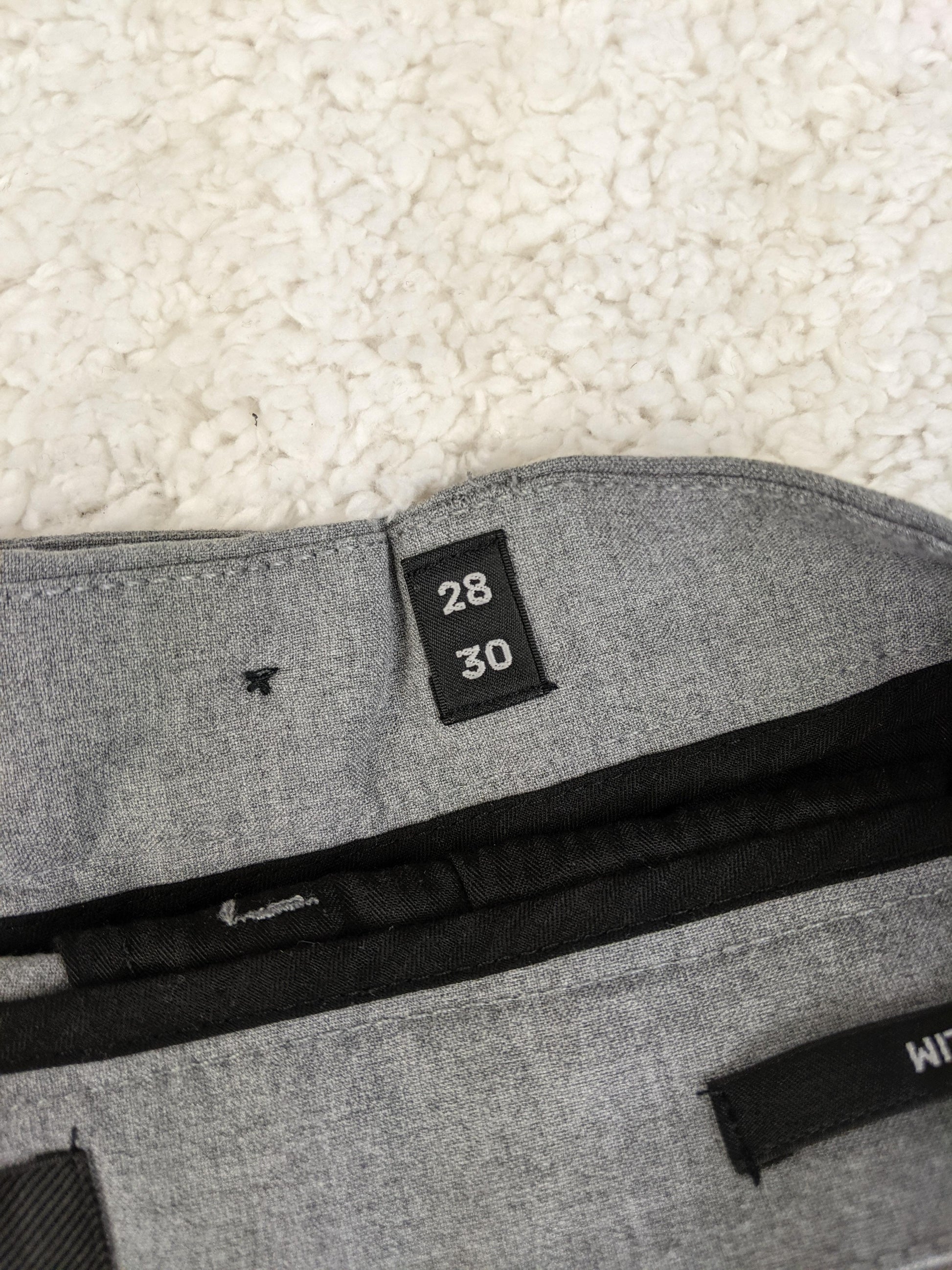 Size label of Jack & Jones grey pants showing size 28/30