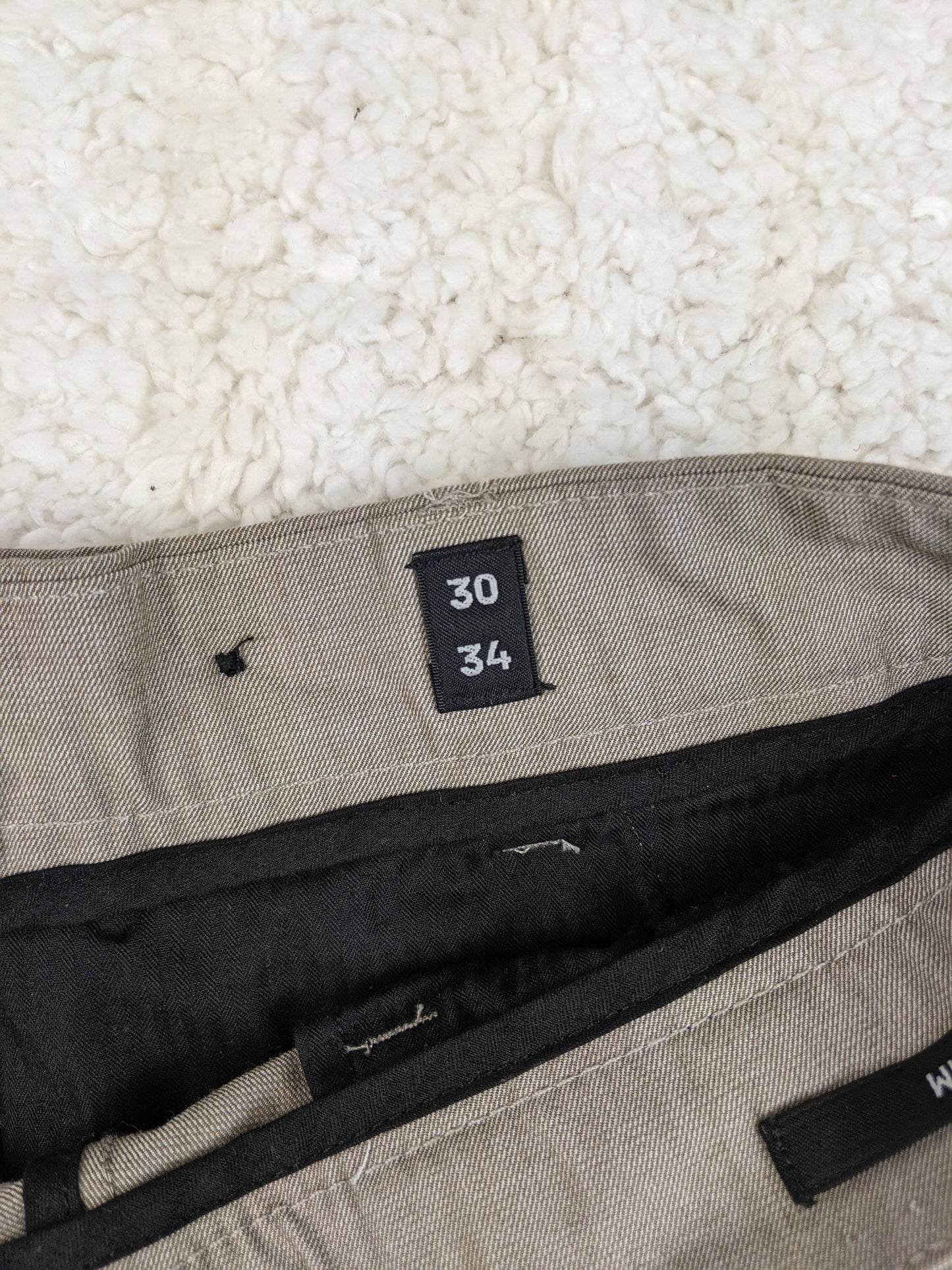 Size label showing 30/34 on the trousers