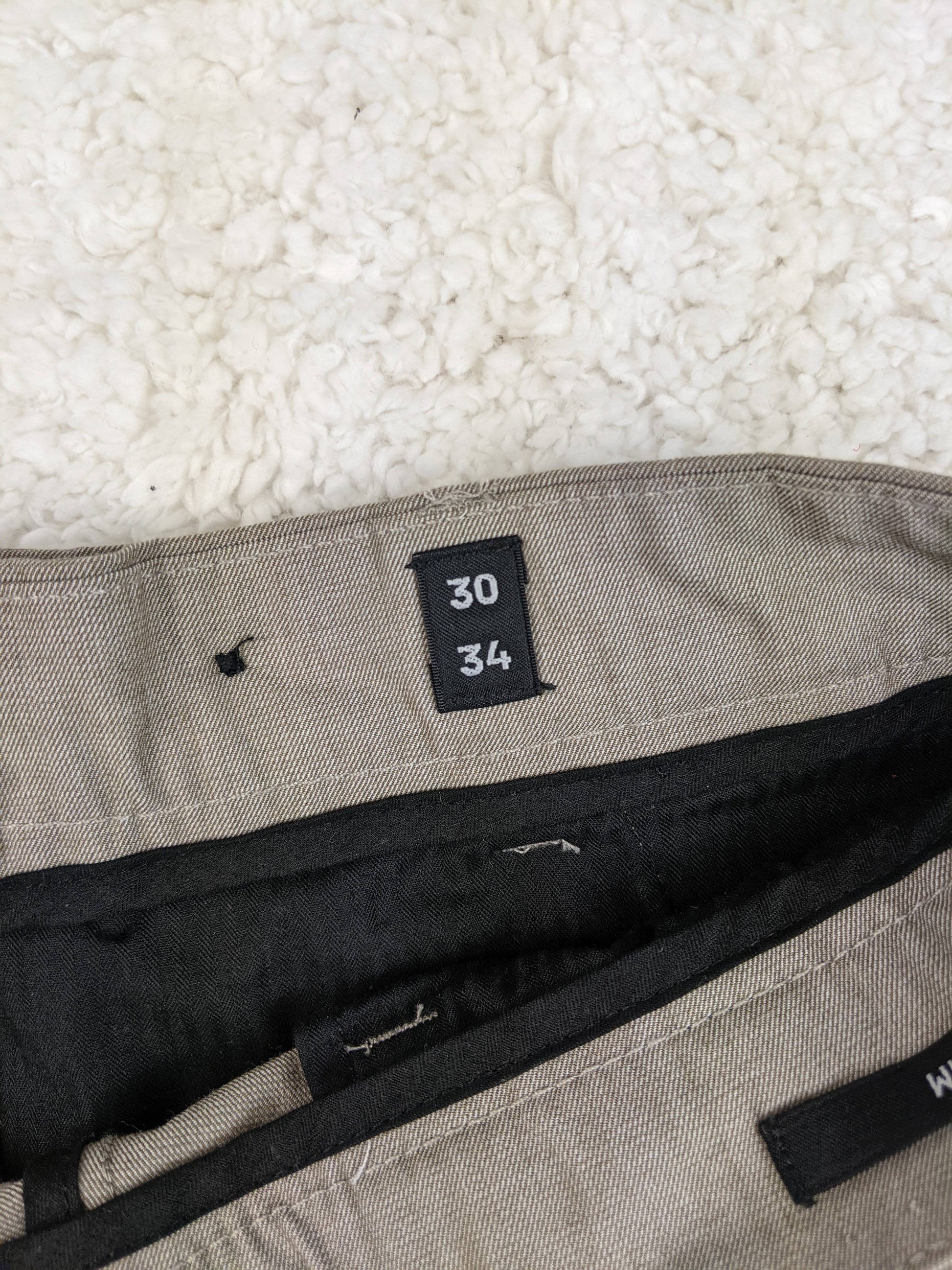 Size label showing 30/34 on the trousers
