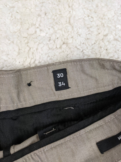 Size label showing 30/34 on the trousers