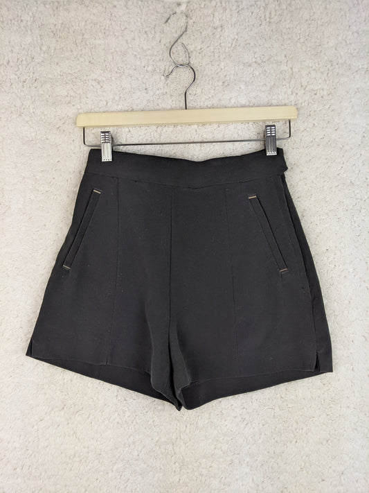 Front view of black shorts on a hanger