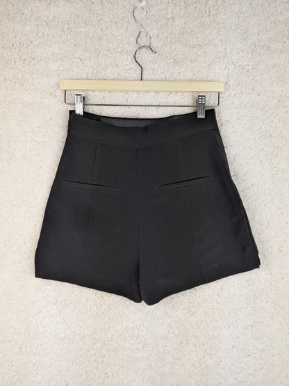 Back view of black shorts on a hanger