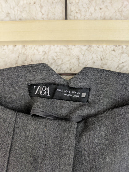 Close-up of Zara label on grey trousers