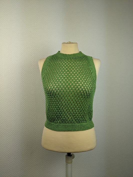 Front view of green crochet sleeveless top on a mannequin