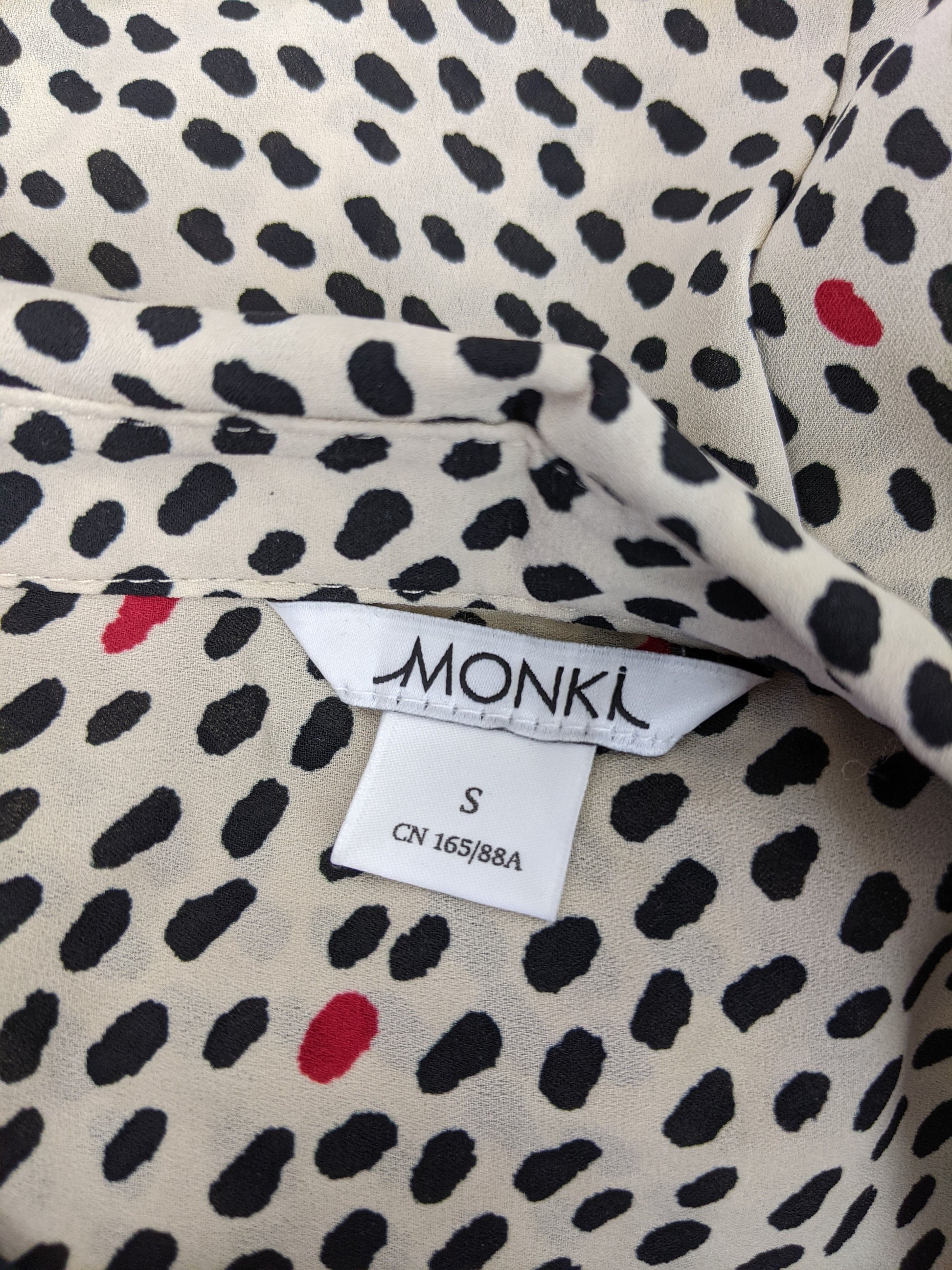 Close-up of Monki label on shirt