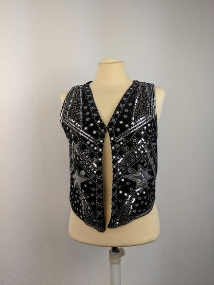 Front view of black sequined vest on mannequin