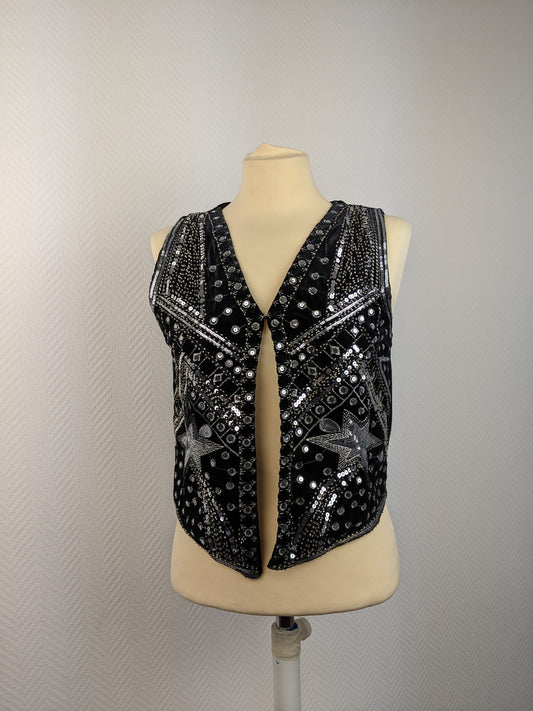 Front view of black sequined vest on mannequin