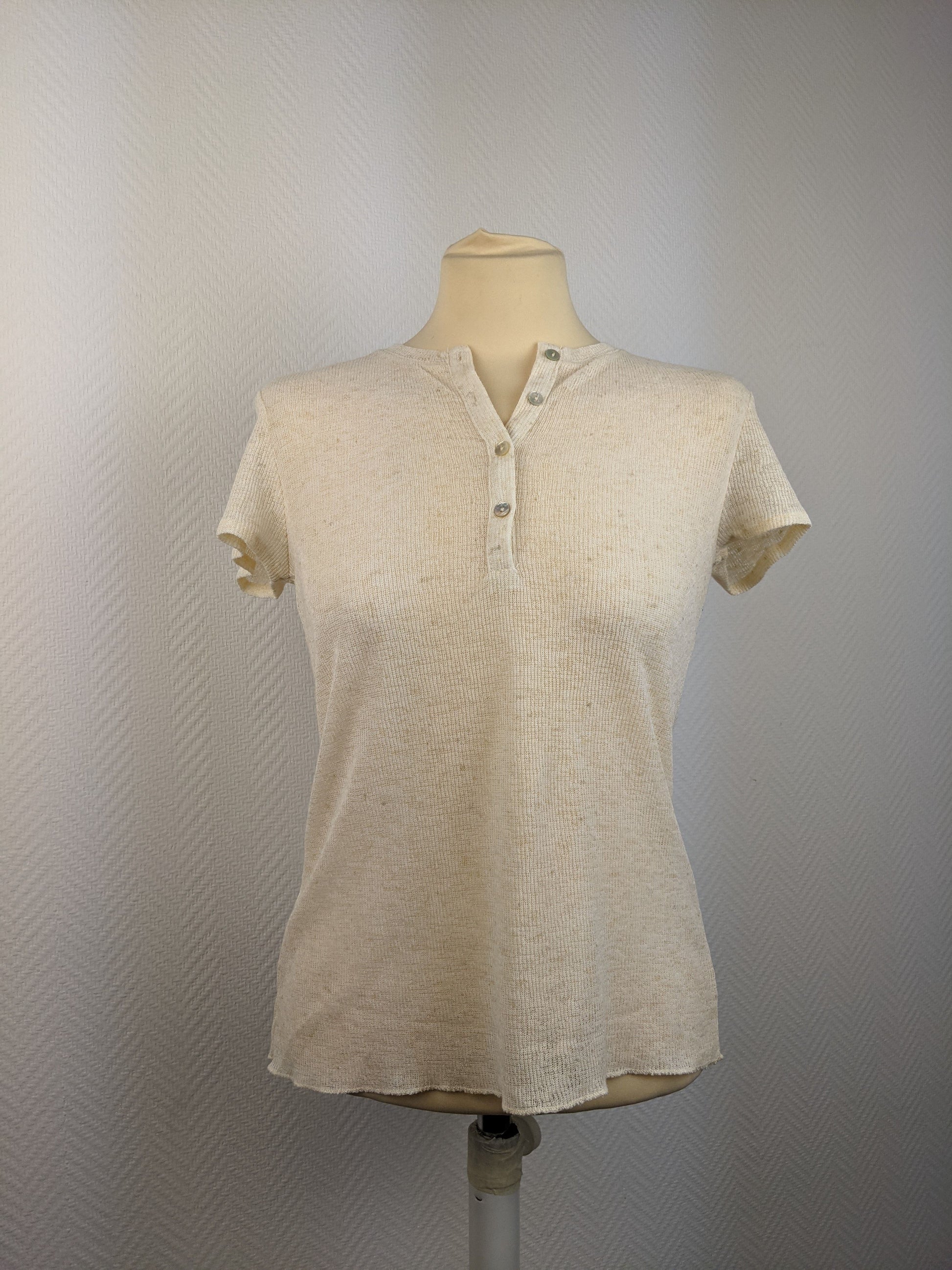 Front view of a beige short sleeve button-up top