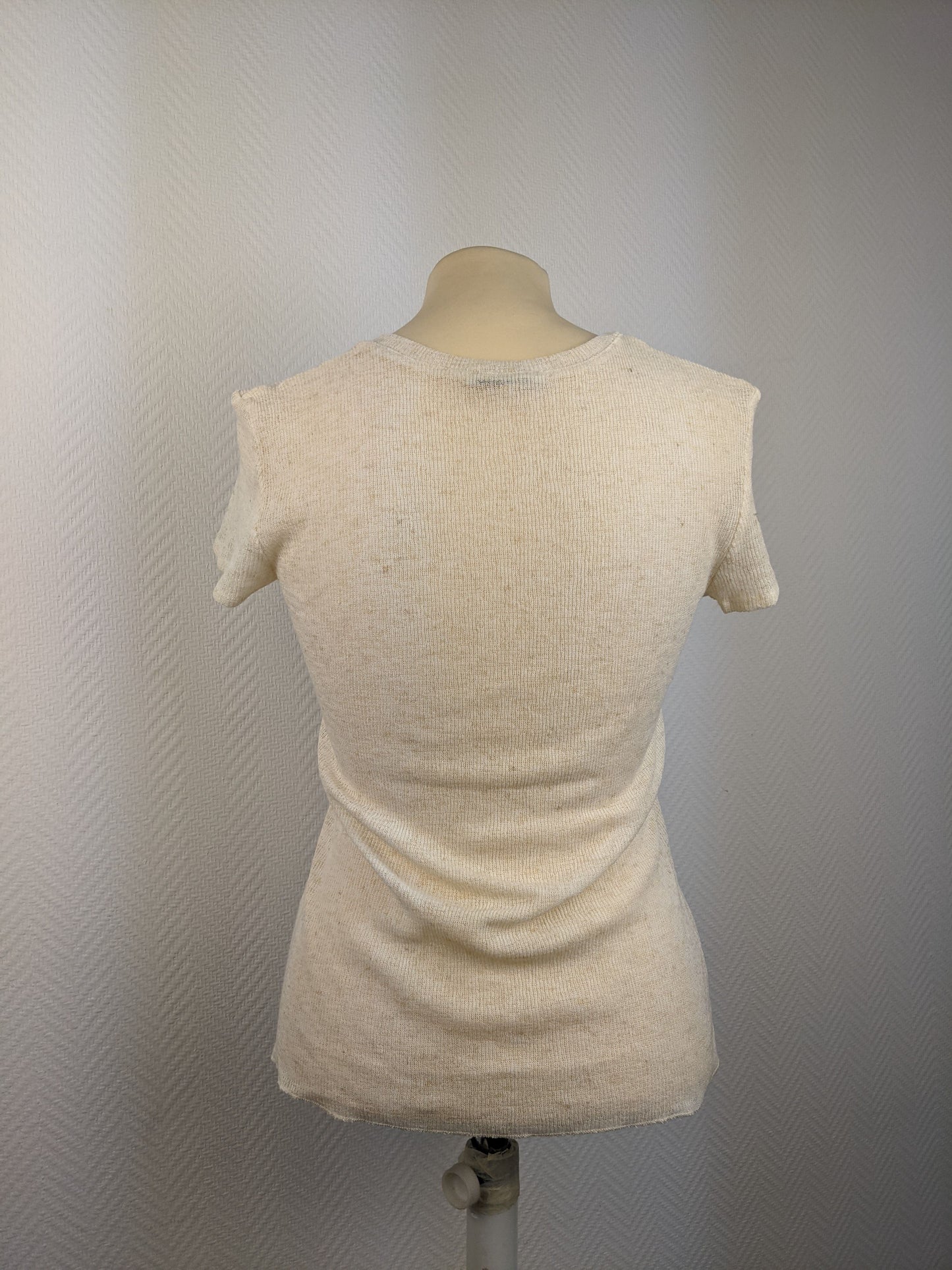 Back view of a beige short sleeve button-up top