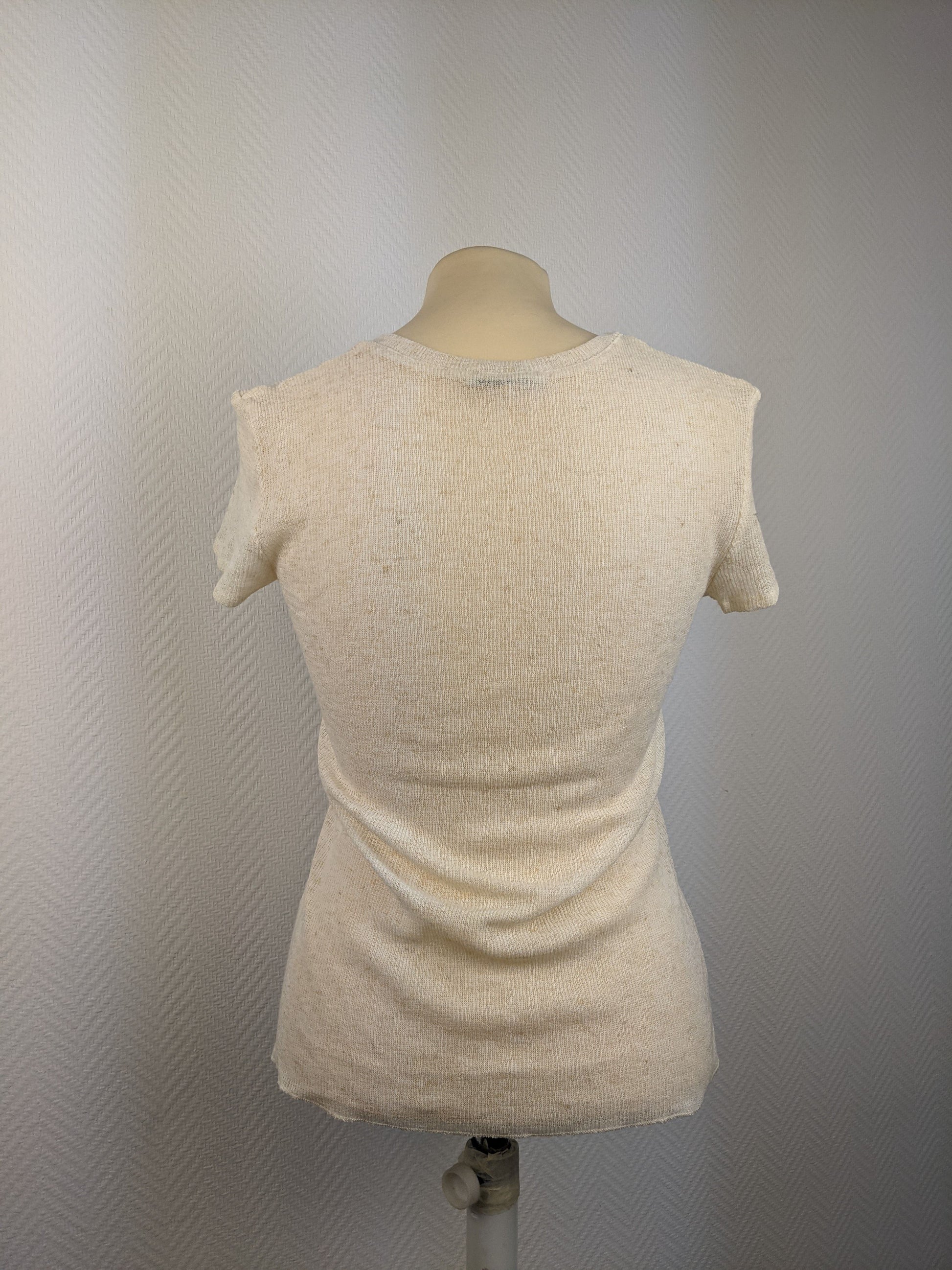 Back view of a beige short sleeve button-up top