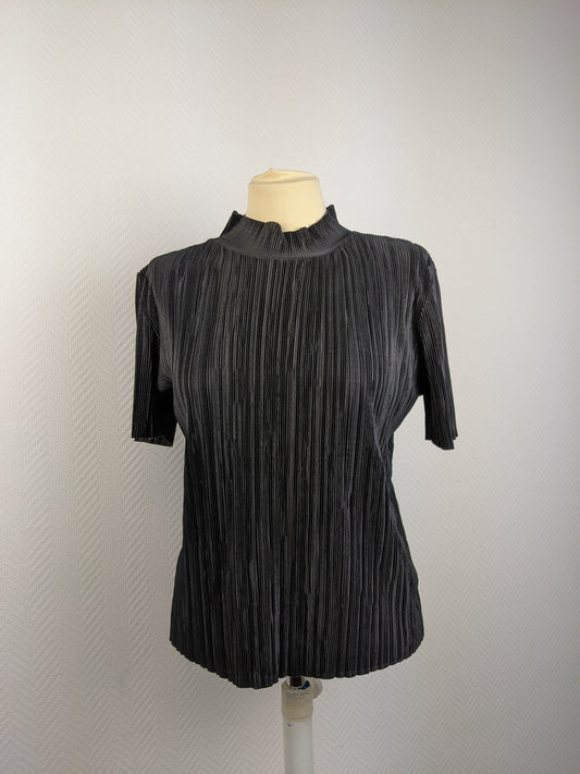 Front view of black pleated top on mannequin