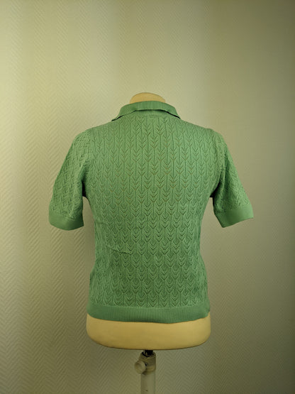 Back view of green knit polo shirt on mannequin
