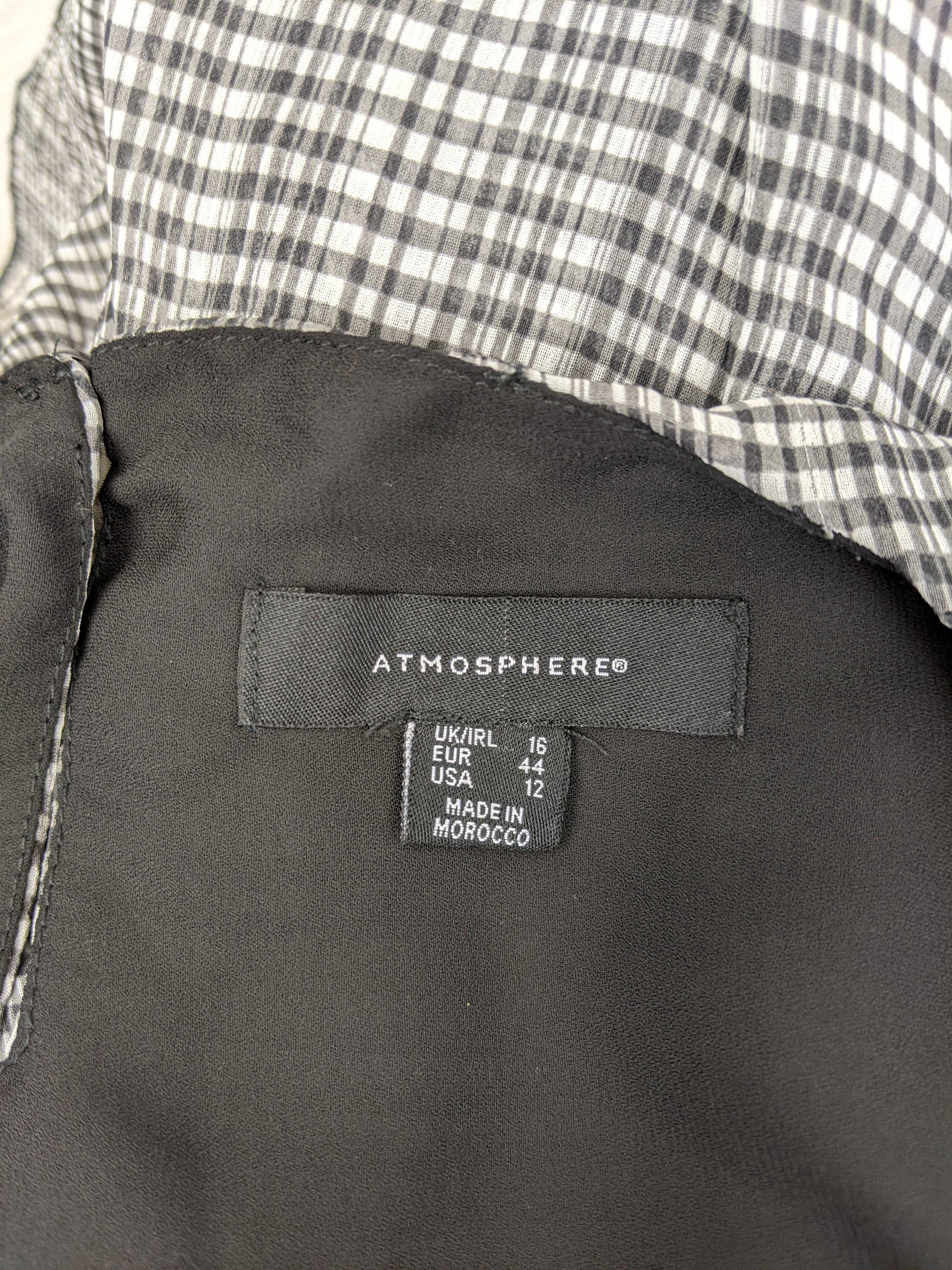 Close-up of Atmosphere brand label and size tag