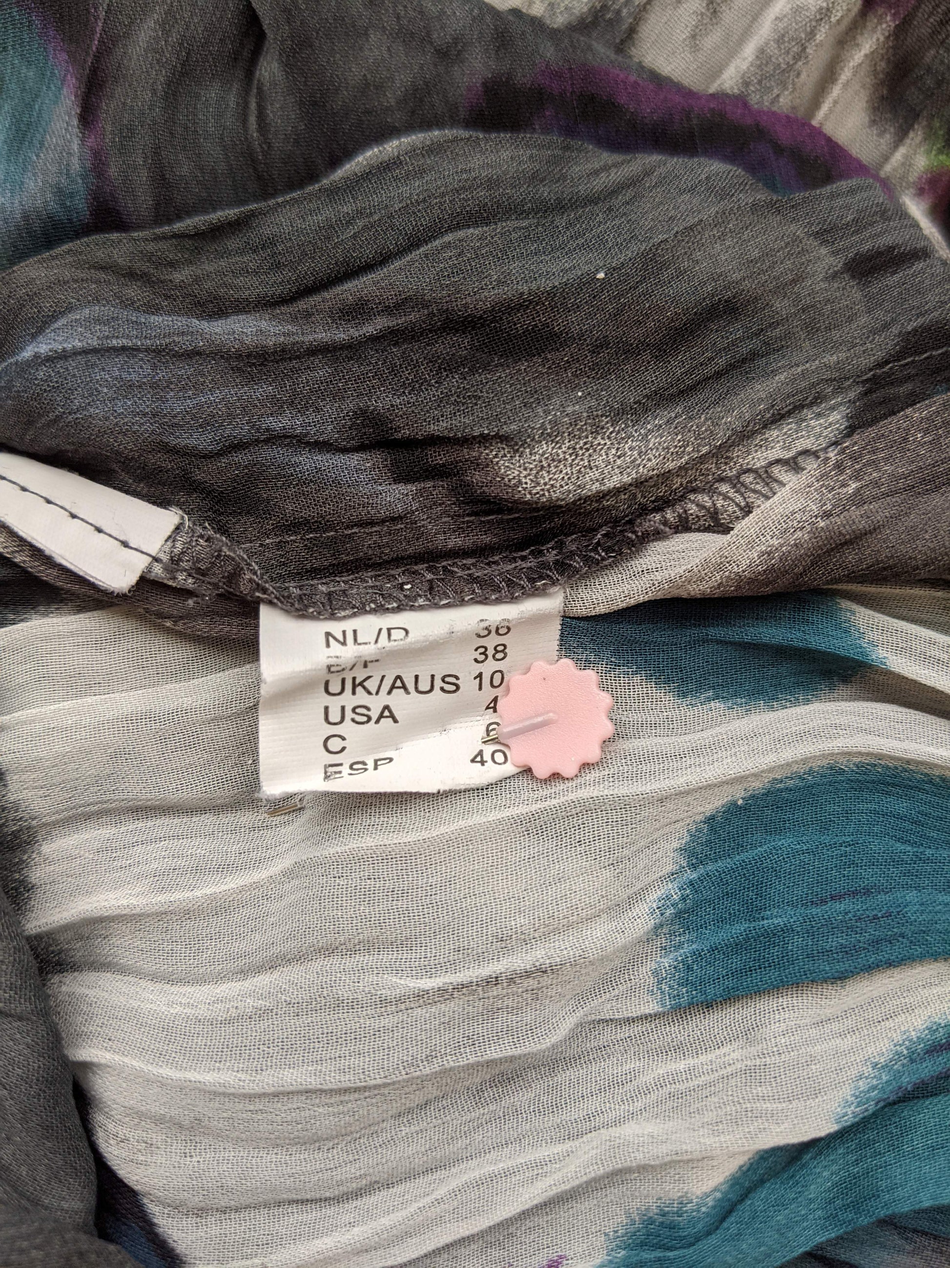 Size tag on colorful dress showing size 38