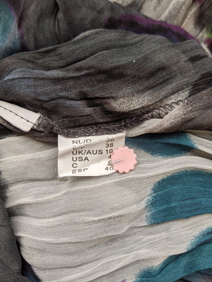 Size tag on colorful dress showing size 38