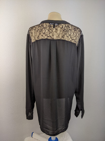 Back view of black blouse showing intricate lace design