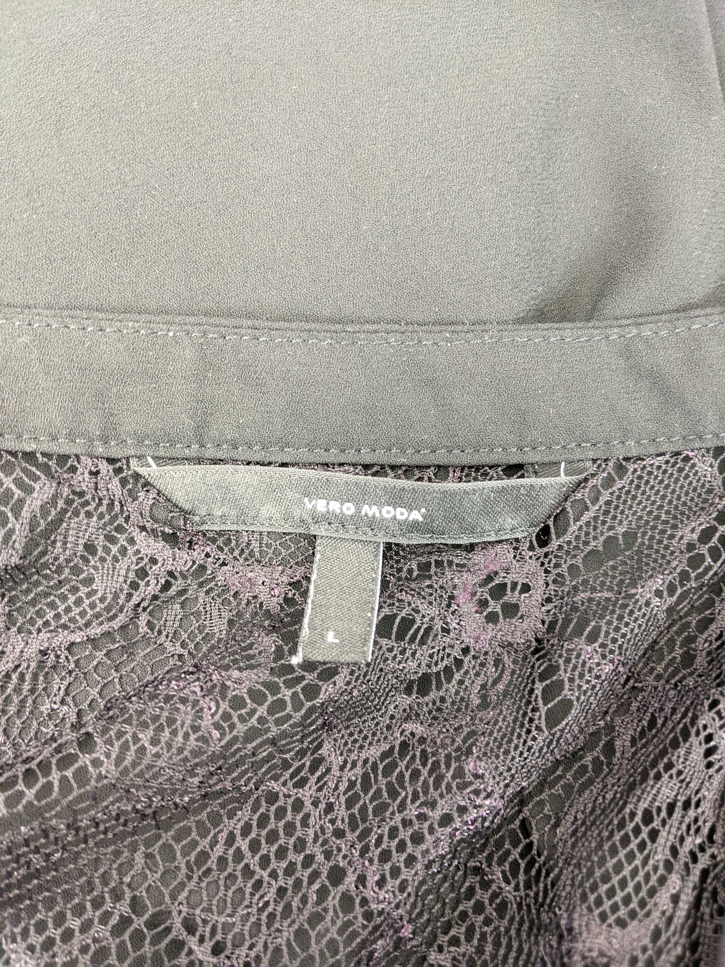 Close-up of Vero Moda label on black blouse