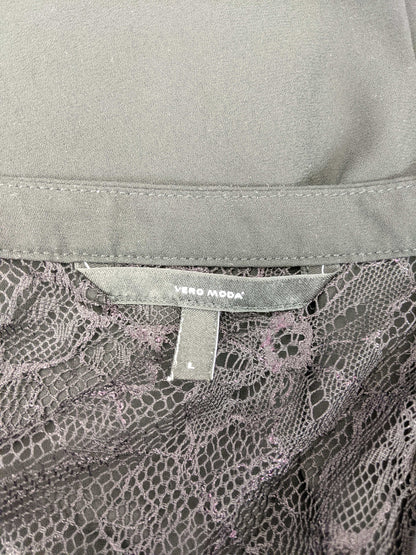 Close-up of Vero Moda label on black blouse