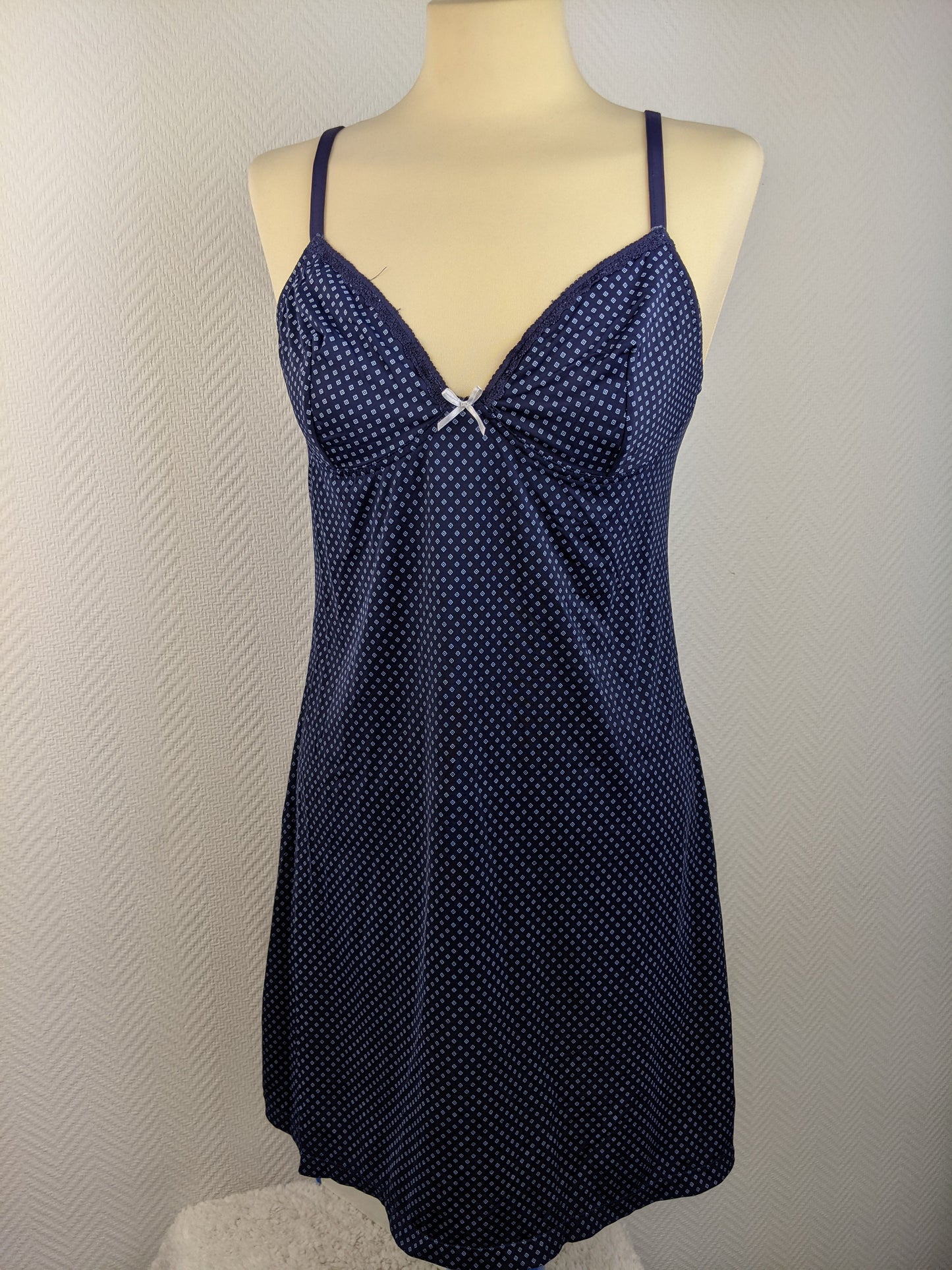 Front view of blue polka dot slip dress on mannequin