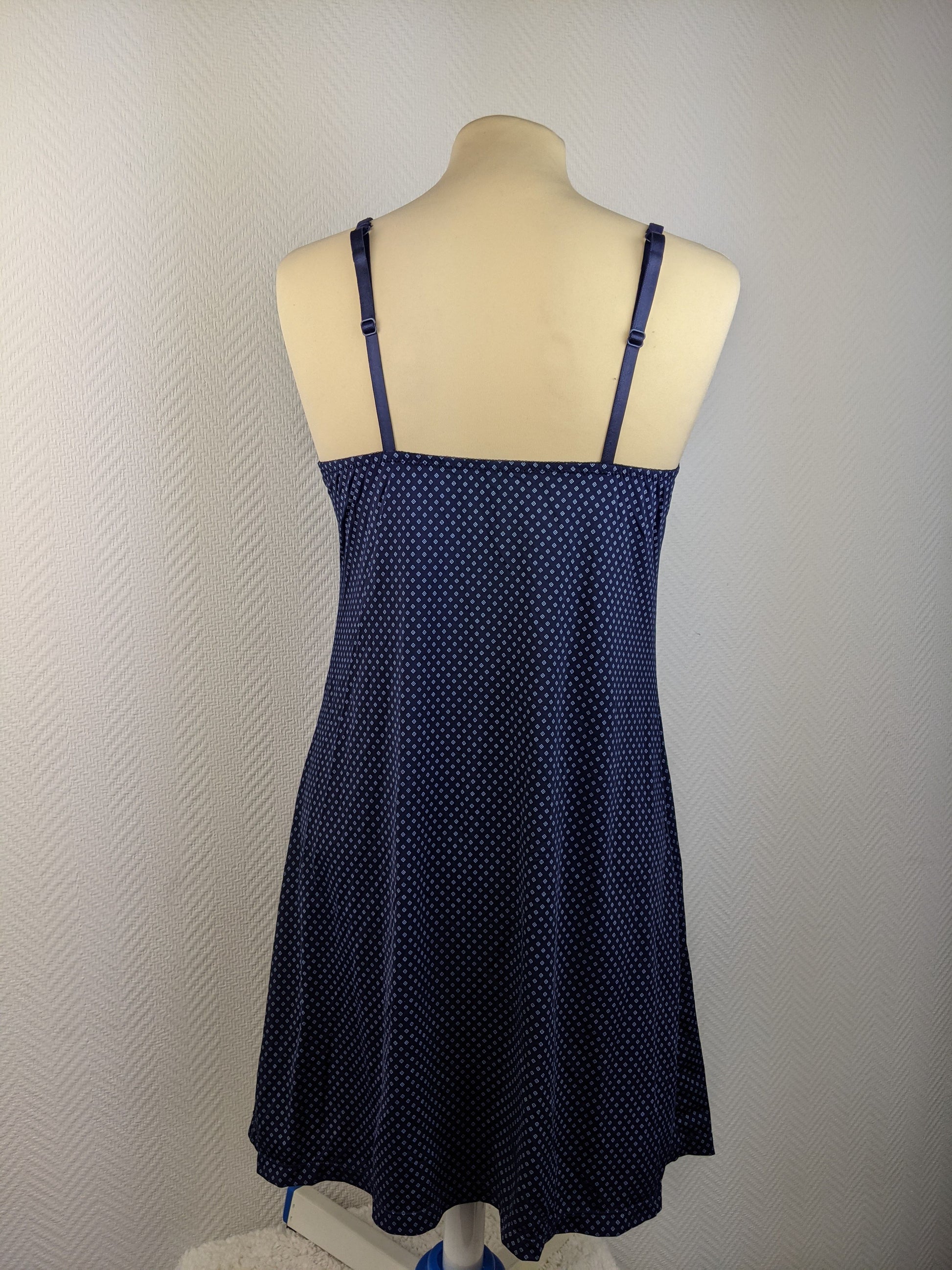 Back view of blue polka dot slip dress showing adjustable straps
