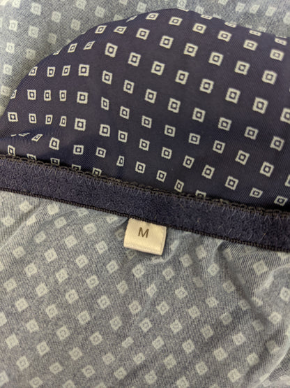 Close-up of size label on blue polka dot slip dress