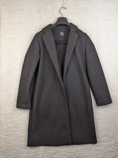 Front view of black coat hanging on a hanger