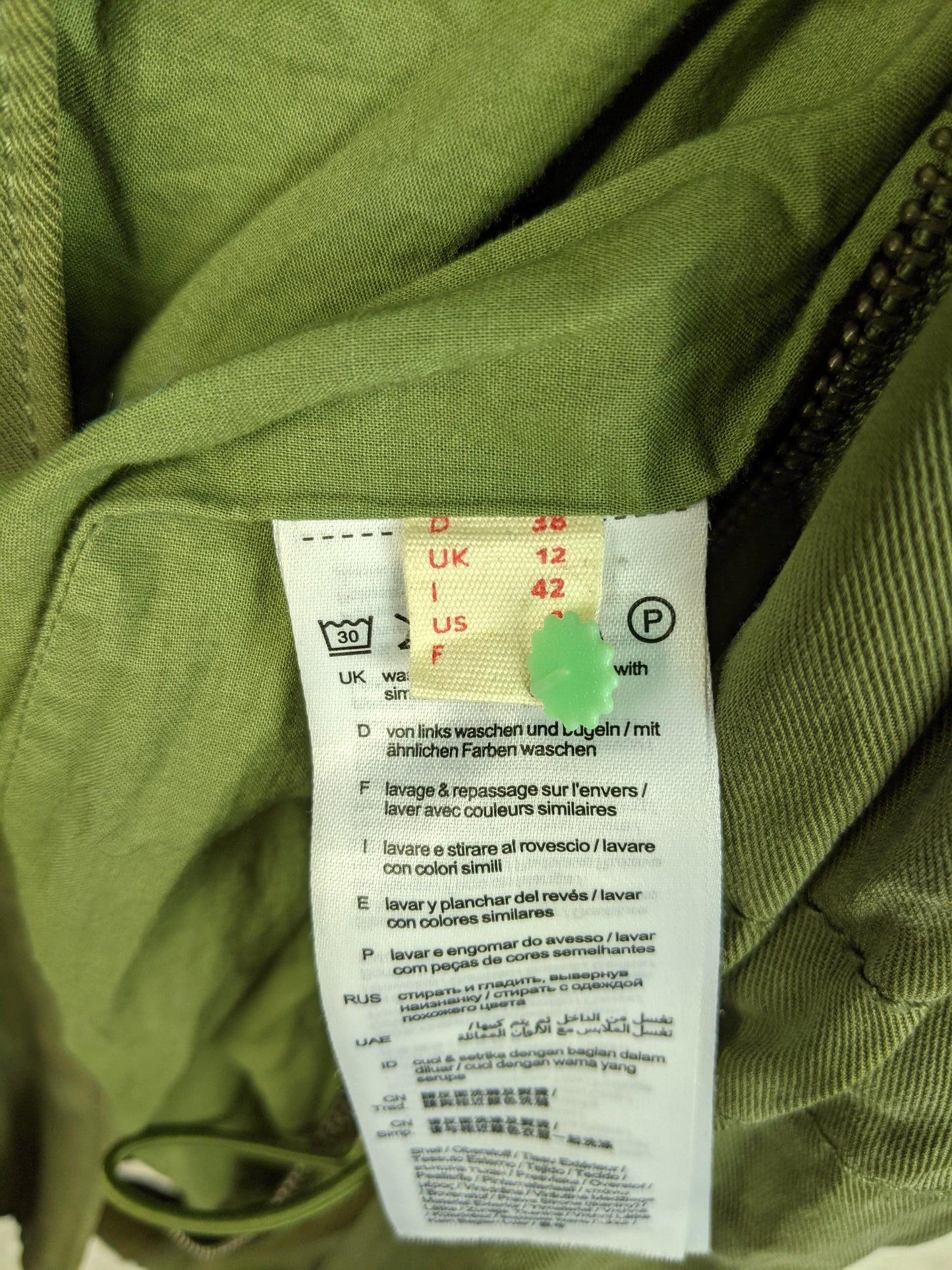 Size and care label inside olive green jacket