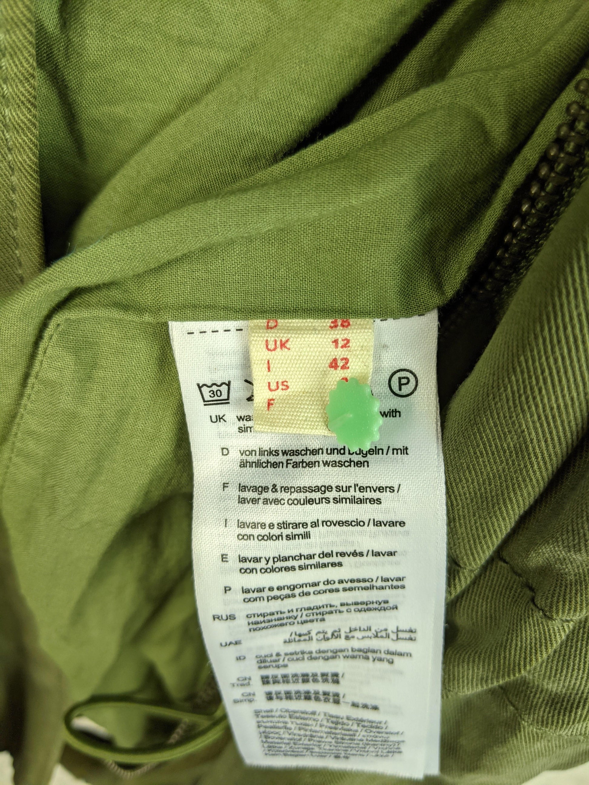 Size and care label inside olive green jacket