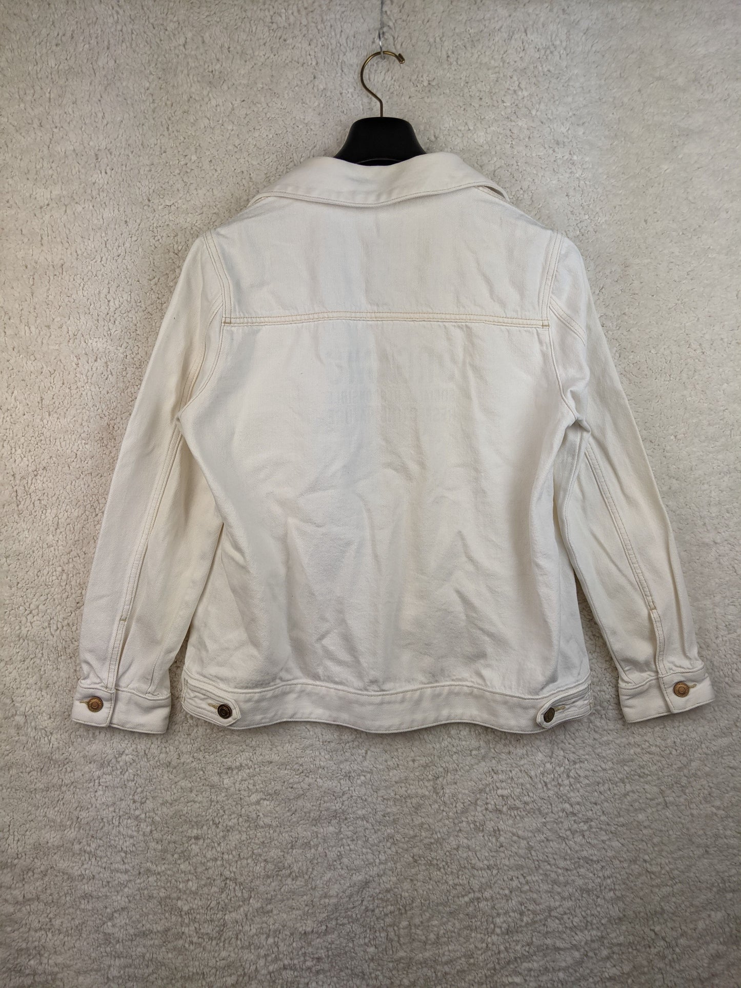 Back view of white sustainable denim jacket
