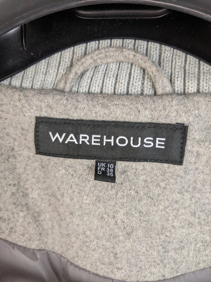 Close-up of Warehouse brand label and size (UK 10, FR 38, D 36)