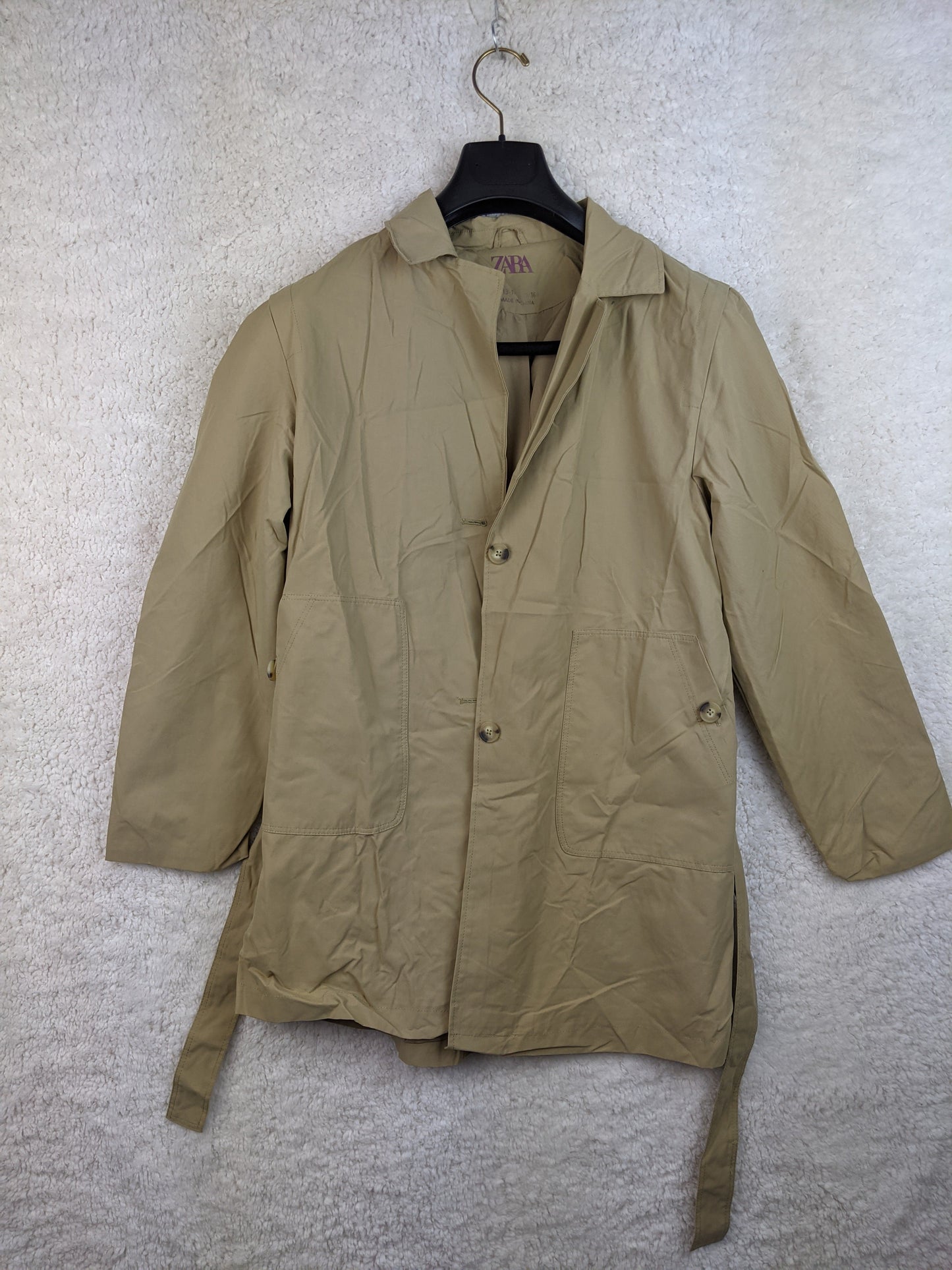 Beige lightweight jacket on hanger, front view