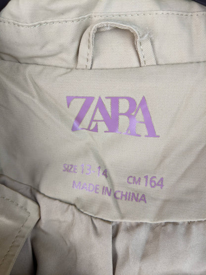 Close-up of Zara label on beige jacket
